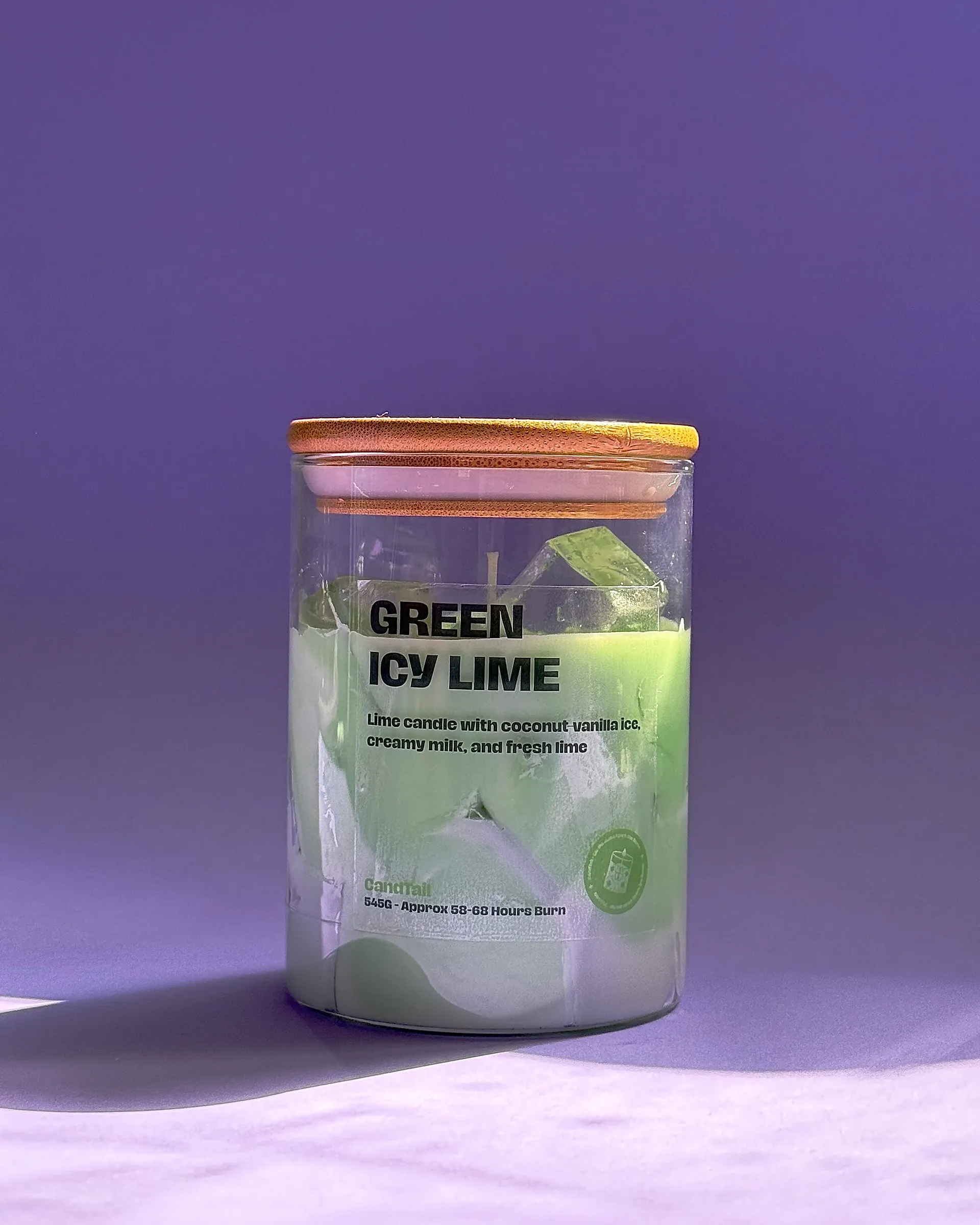 Green Icy Lime candle photographed against a purple backdrop