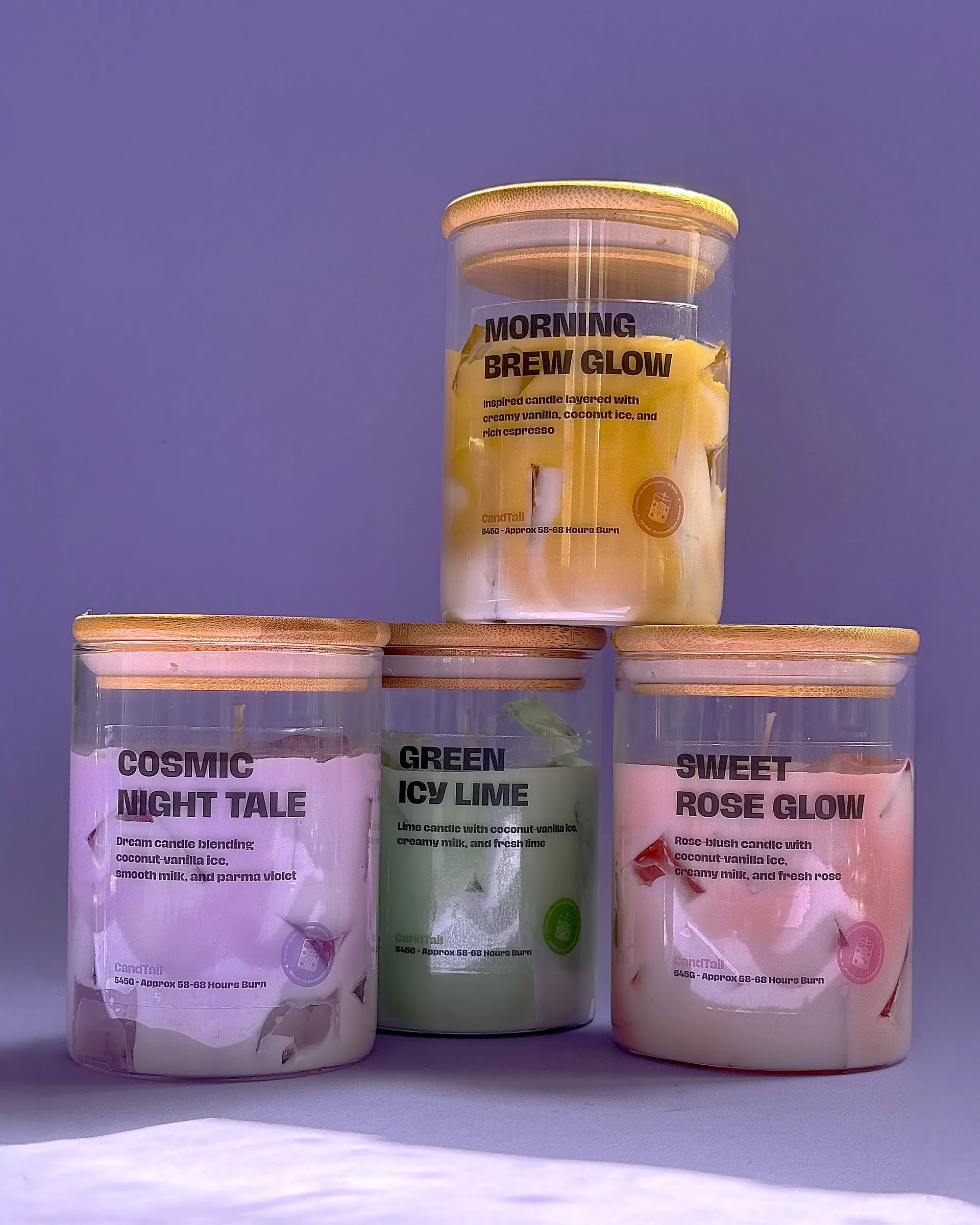 Four Candtail candles stacked against a purple backdrop